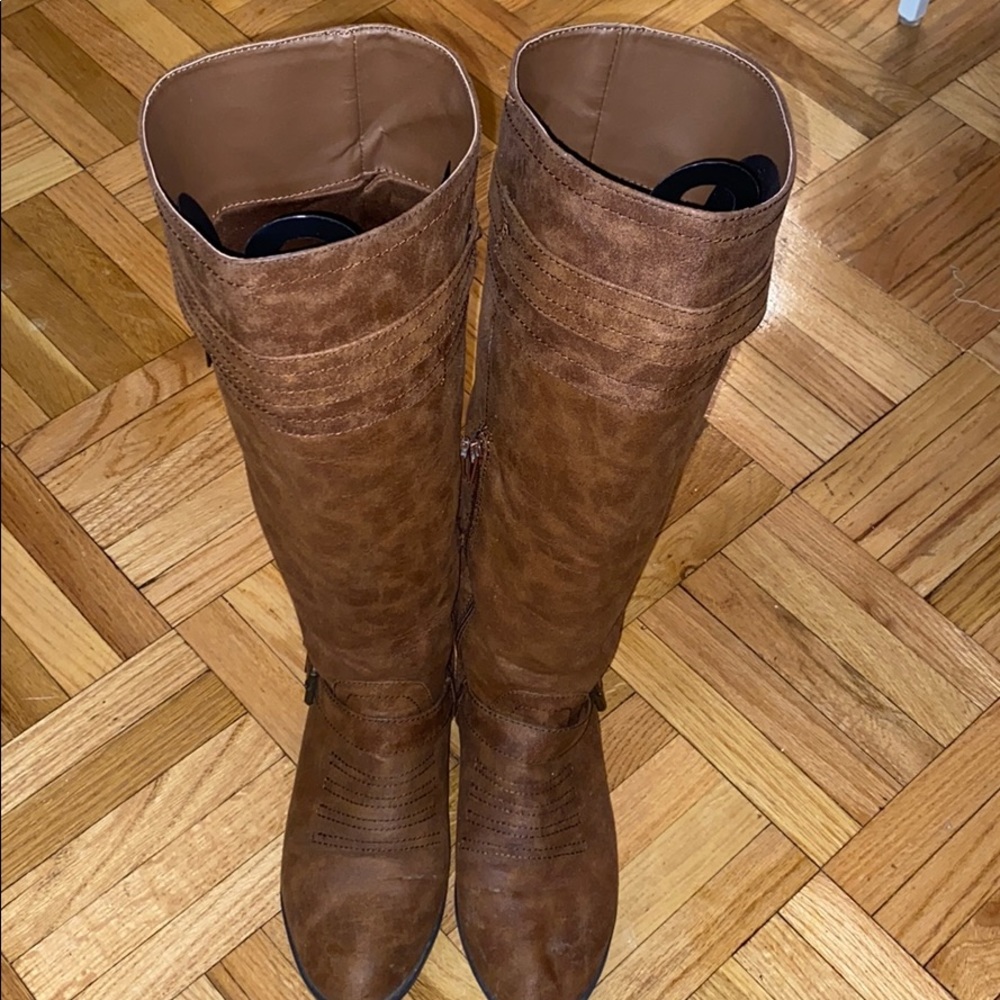 Tall brown leather buckle boots